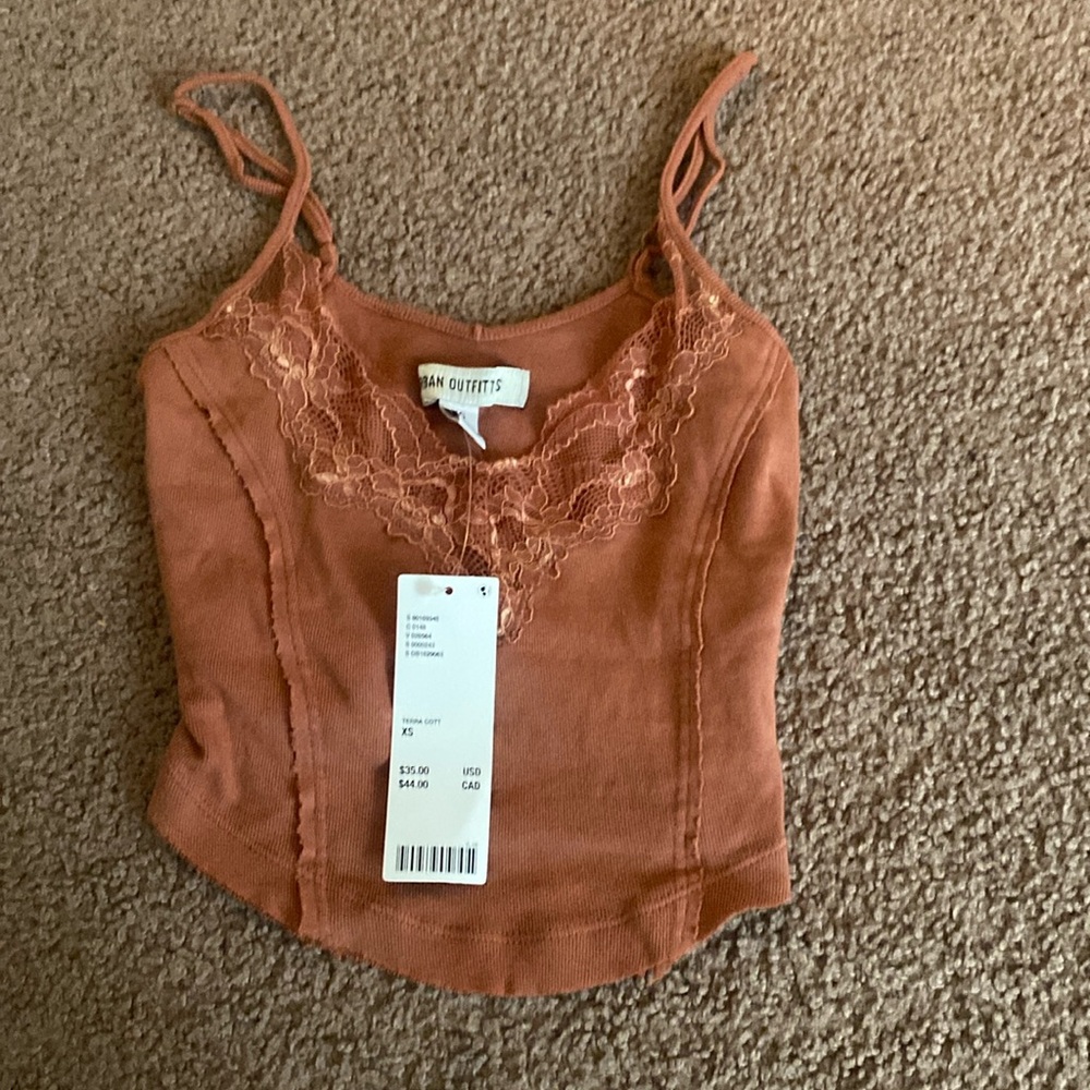 Urban Outfitters rust tank top with lace designs.